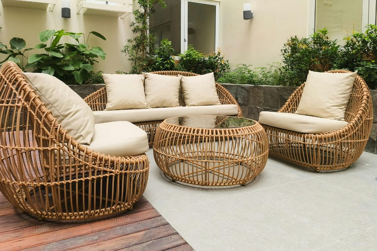Wicker patio furniture set with cushions, featured in a guide to repairing wicker furniture.
